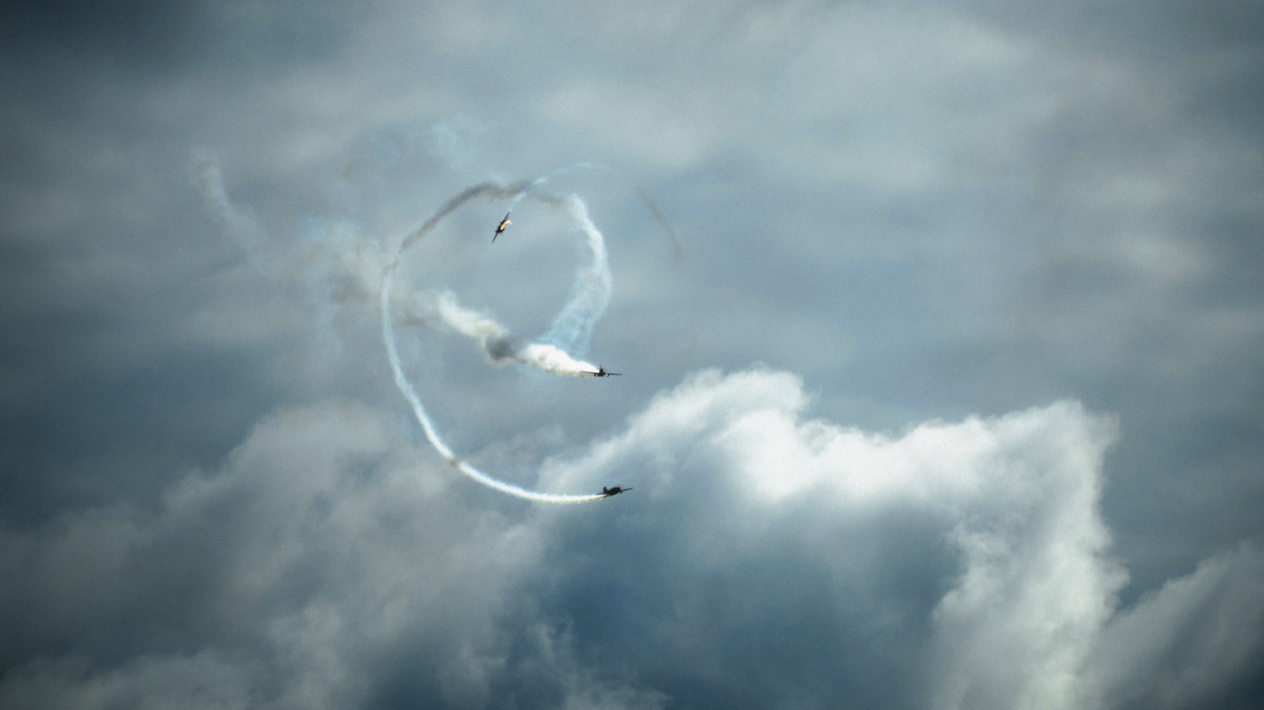 Aircraft drawing a circle of smoke in the sky