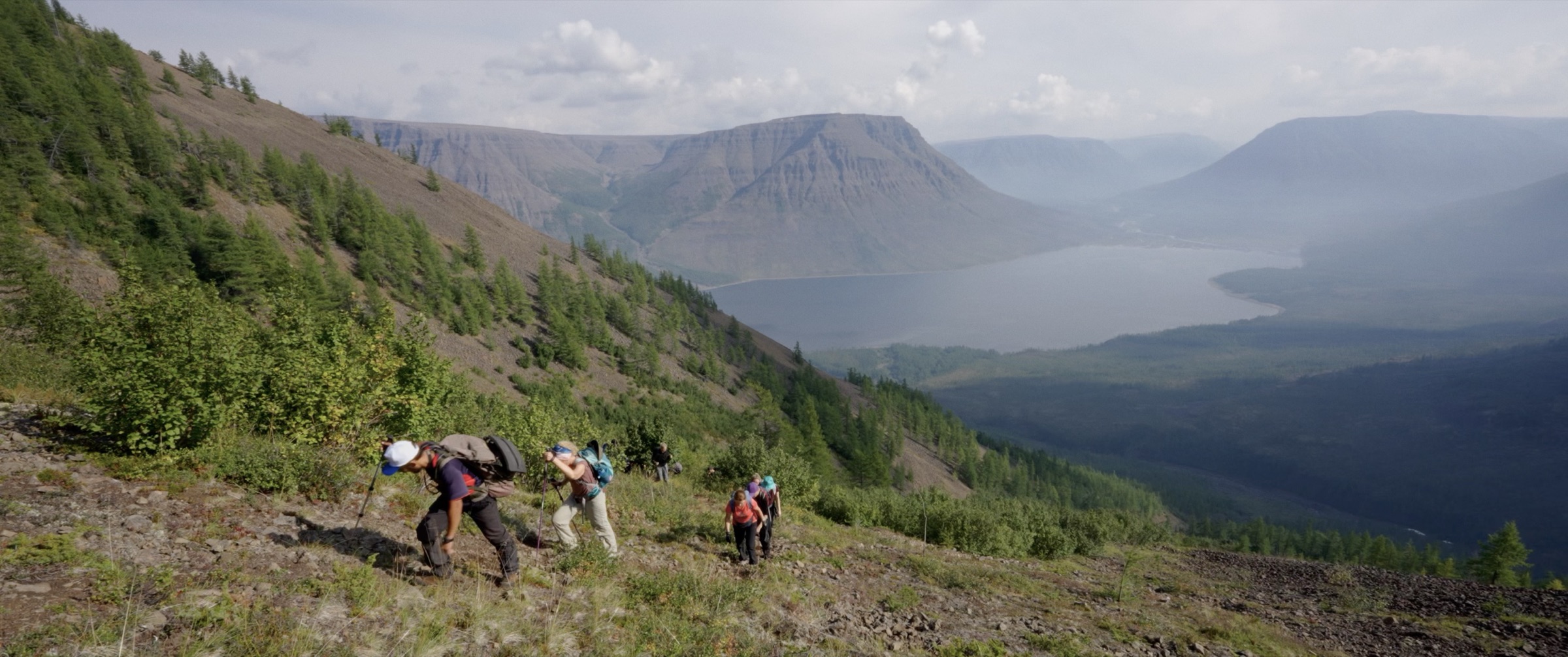 Travellers climbing above a lake on the Putorana Plateau