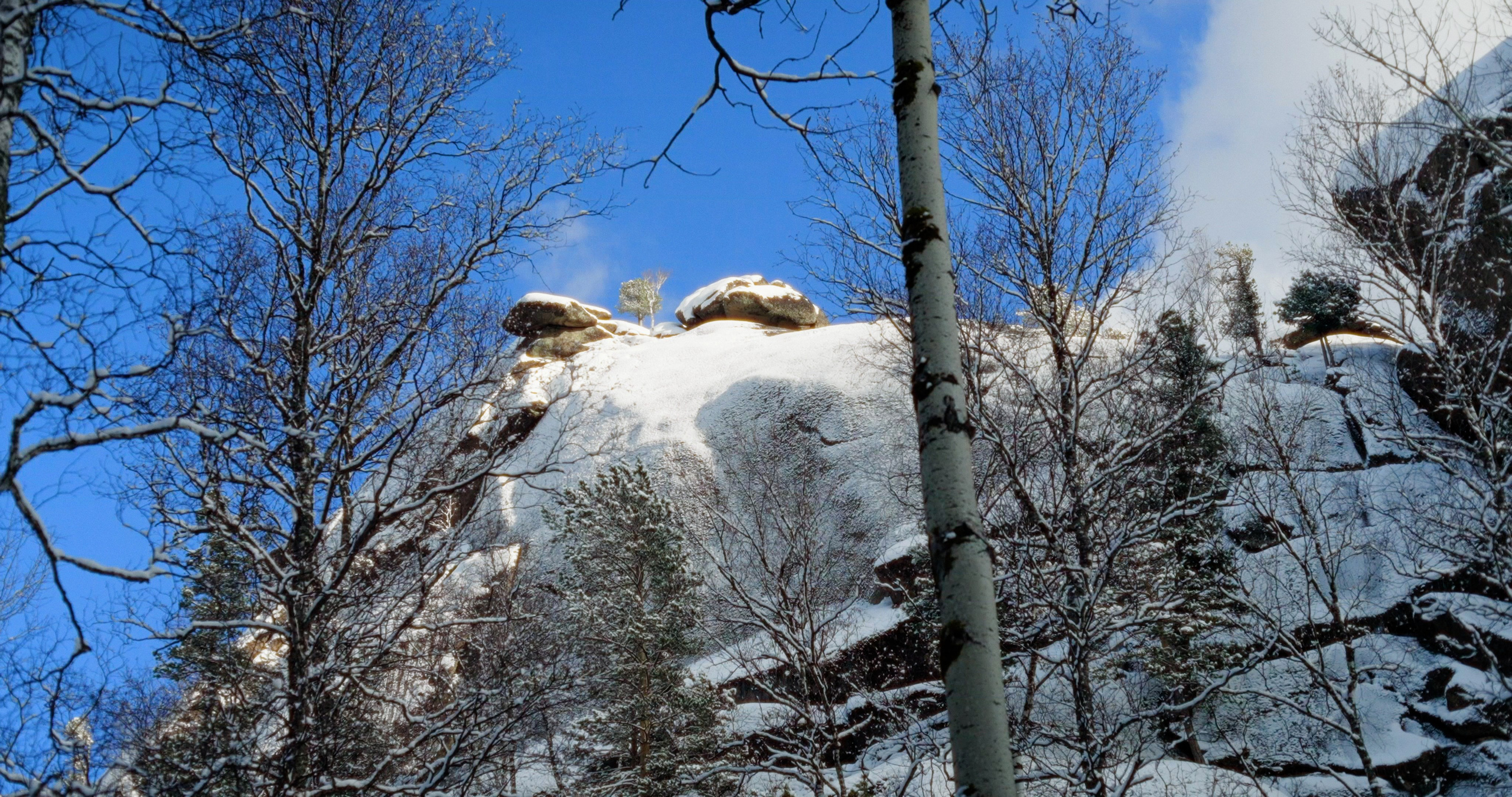 Snow-covered rocks in the taiga